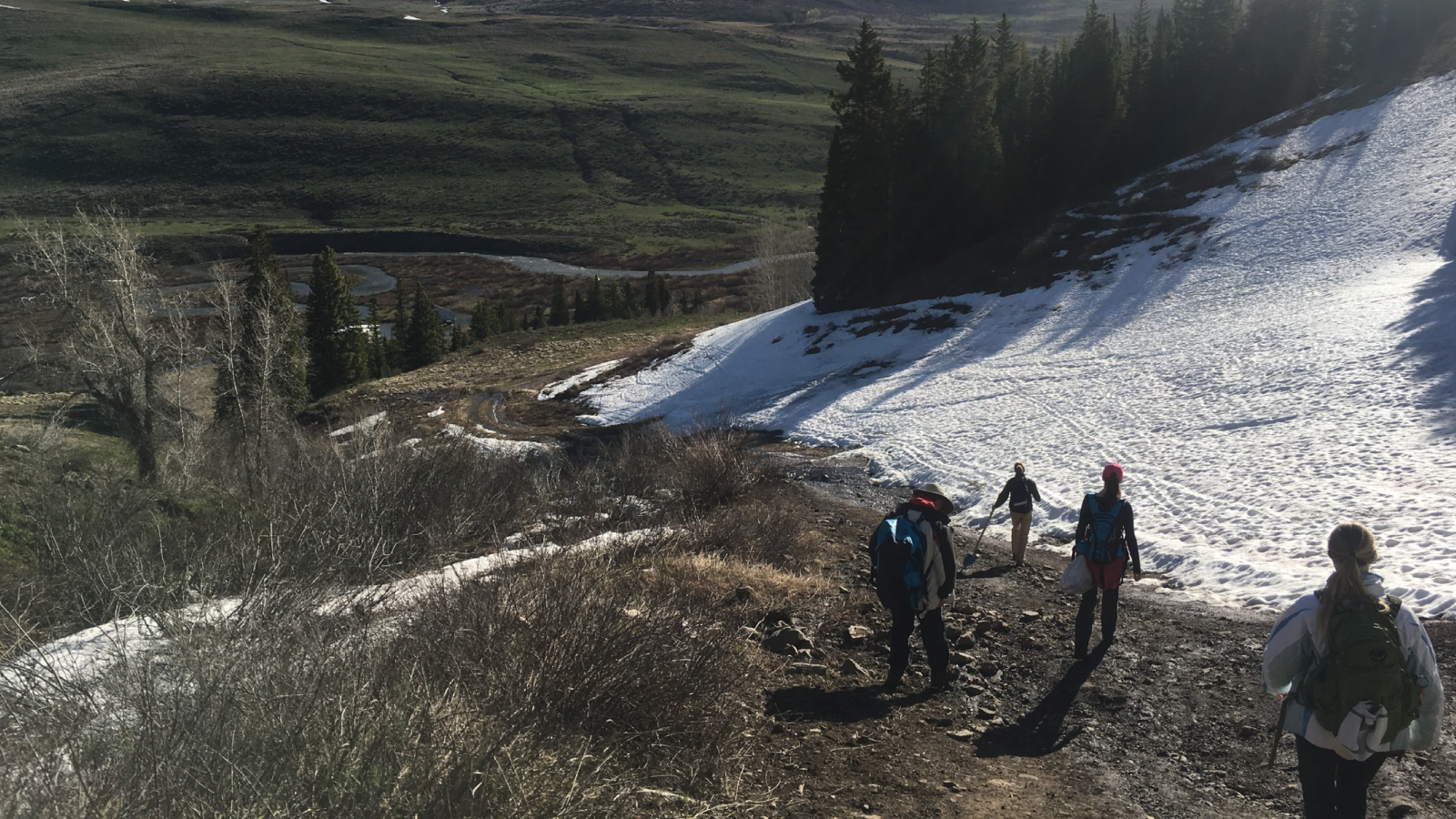 Students hiking towards East River near Crested Butte, CO, snowy background