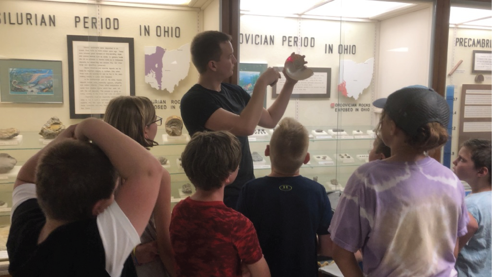 PhD student Ken Peterman teaches school children about fossils in the Orton Geological Museum