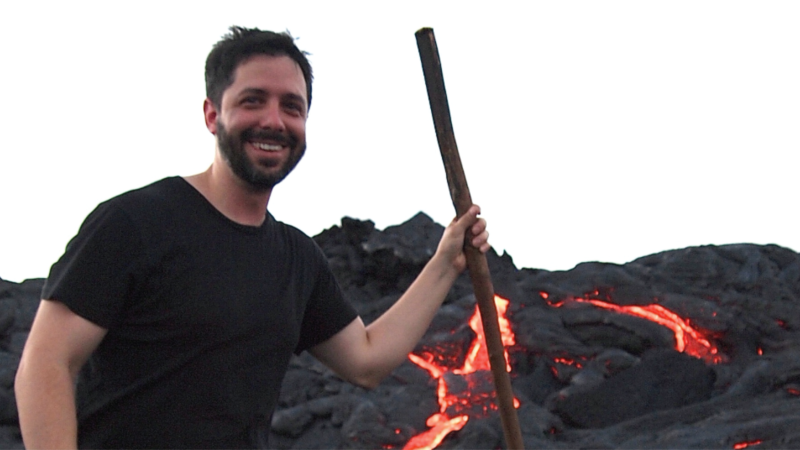 Lawrence Febo in front of a lava field with active flows