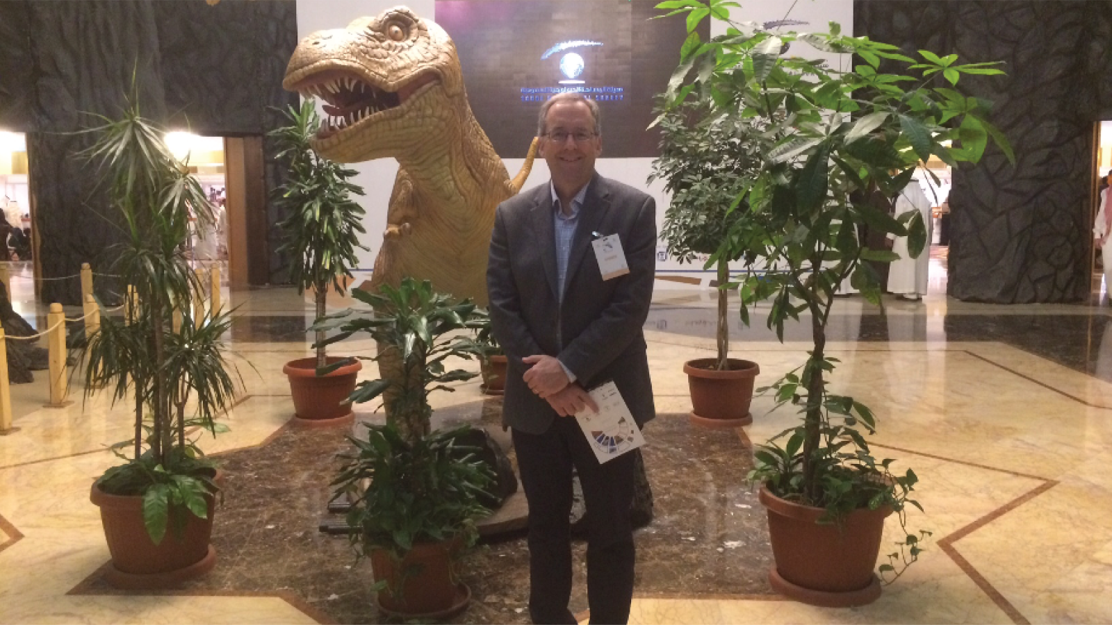 Robert Mellors standing in front of a model T. rex
