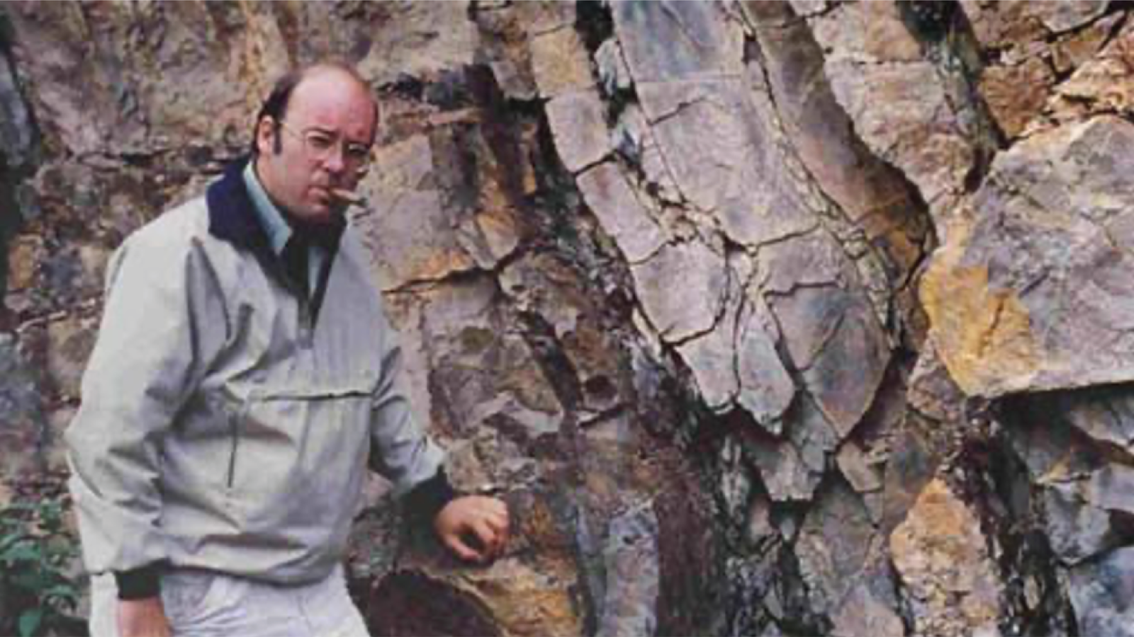 Ronald Nelson standing in front of an outcrop