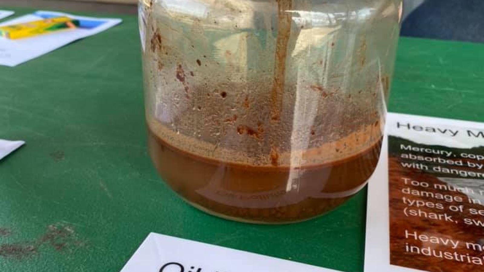 jar showing oil polution
