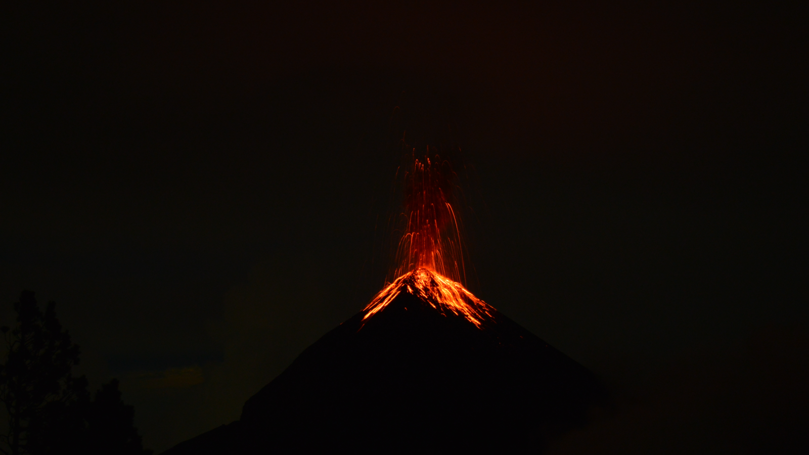 Fountain of Lava erupting from Fuego Volcano at night time