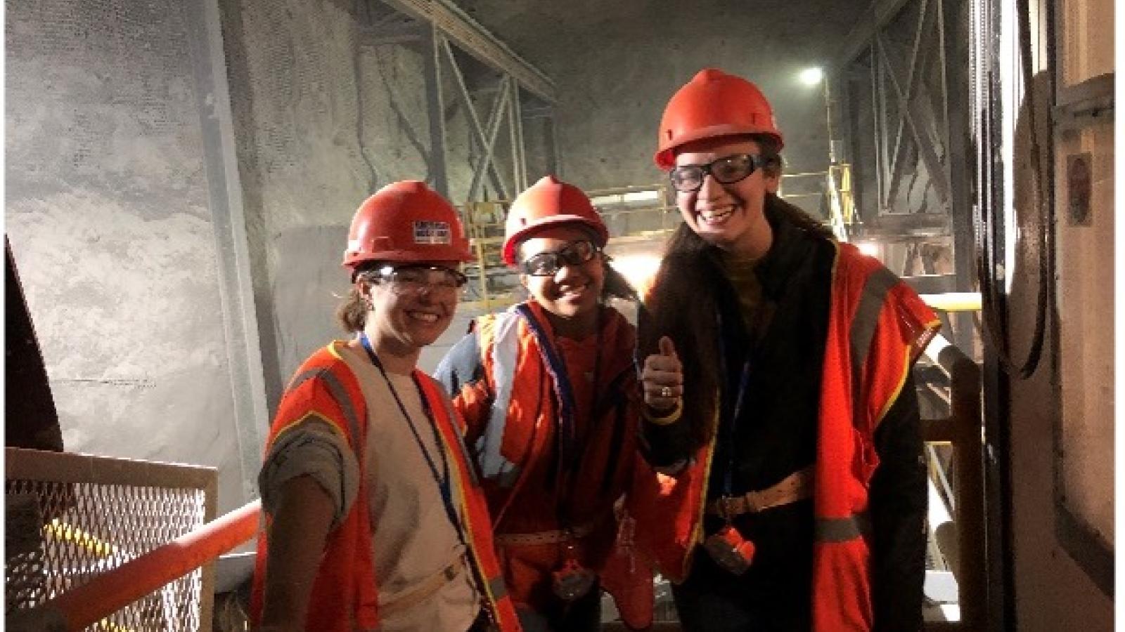 Trio of students smiling at the camera in the salt mines